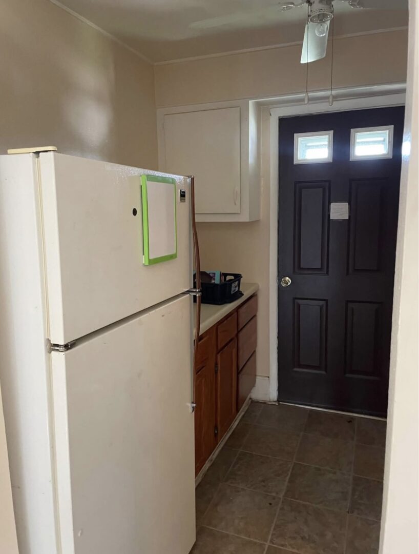 Narrow galley kitchen with refrigerator