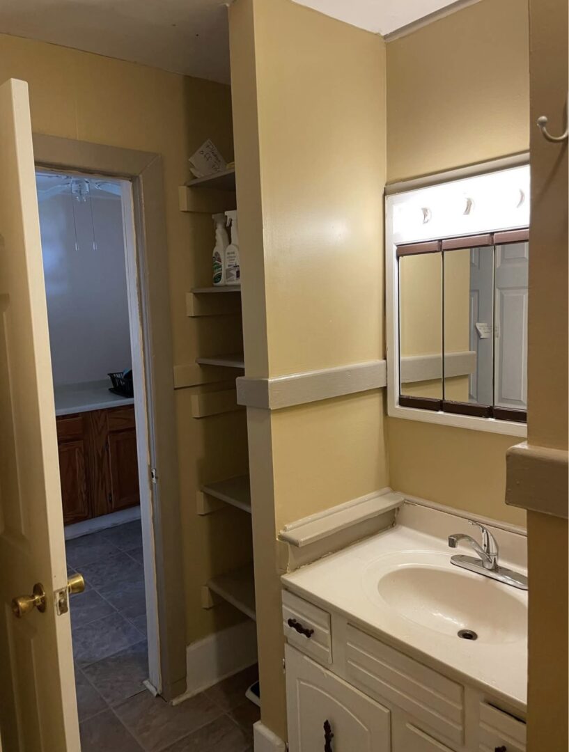 Compact bathroom vanity with shelves and mirror