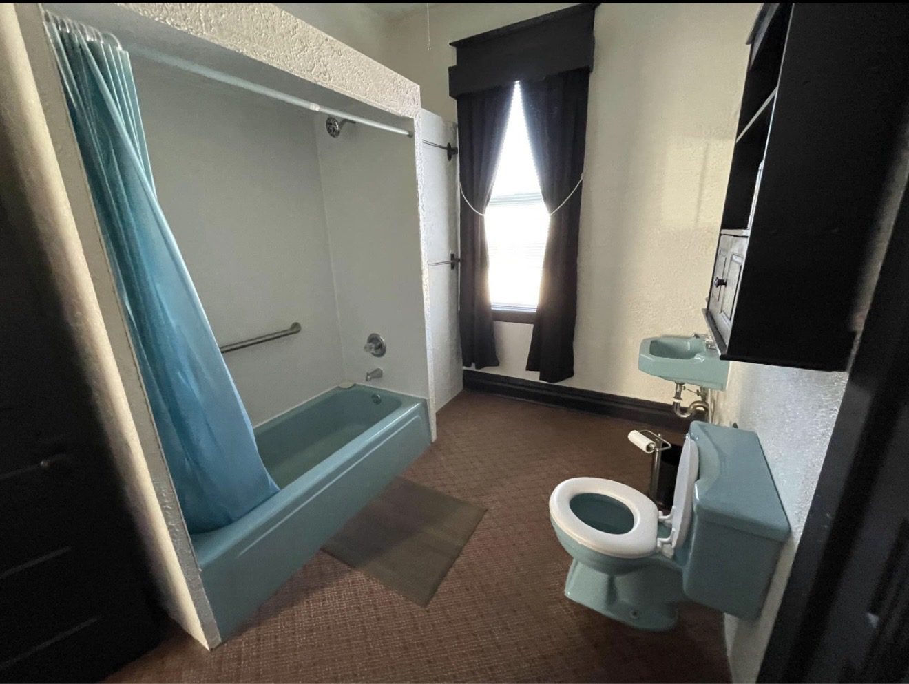Vintage blue bathtub, sink and toilet bathroom