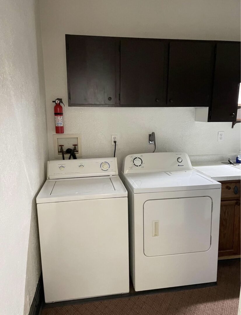 Laundry area with washer, dryer and cabinets